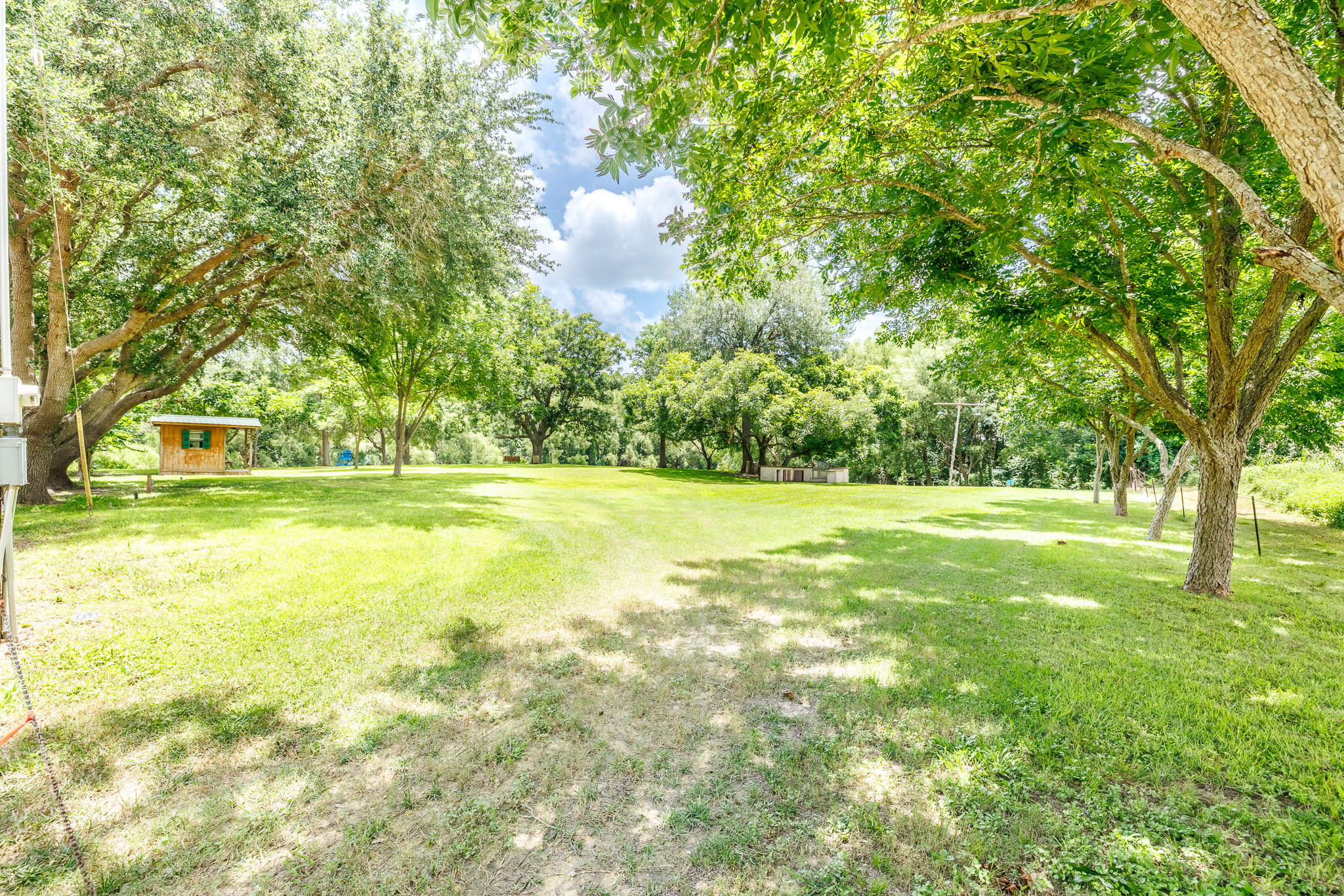 Tbd Goodwin Road Gonzales, TX 78629 - Photo 33 of 33 A verdant, open yard with mature trees offers ample space for outdoor activities and relaxation.
