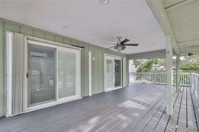 a view of a chair and table in backyard of the house