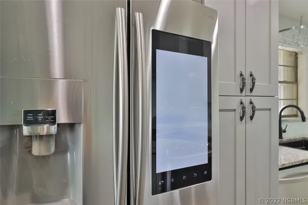 a kitchen with stainless steel appliances granite countertop a sink and cabinets