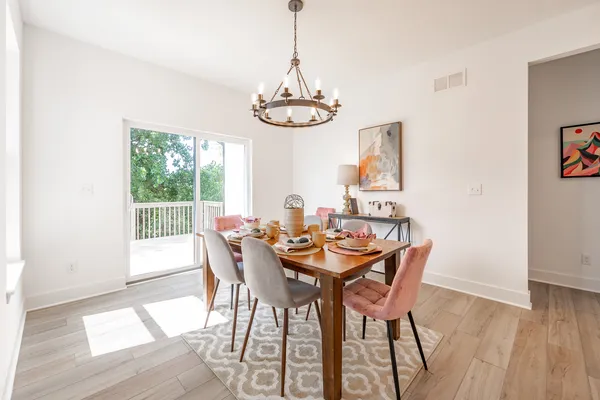 a view of a dining room with furniture window and wooden floor