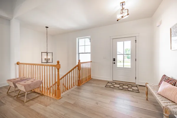 a view of a room with wooden floor windows and a chandelier