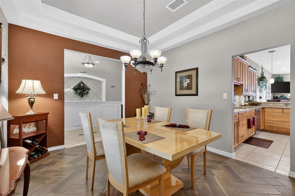 19703 Twin Ponds Road Umatilla, FL 32784 - Photo 11 of 62 a view of a dining room with furniture and a chandelier fan