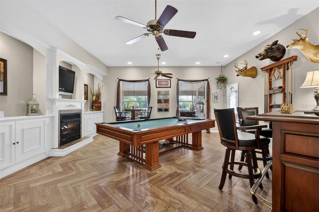 19703 Twin Ponds Road Umatilla, FL 32784 - Photo 13 of 62 a living room with furniture a flat screen tv and kitchen view