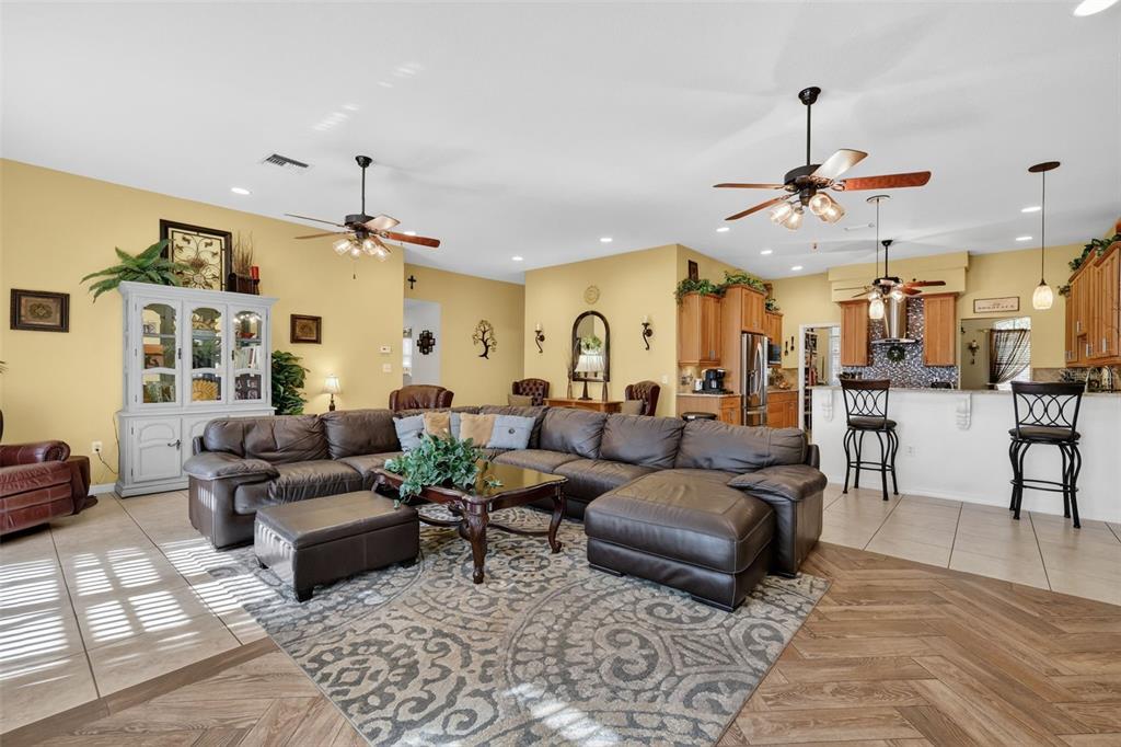 19703 Twin Ponds Road Umatilla, FL 32784 - Photo 18 of 62 a living room with furniture kitchen view and a chandelier