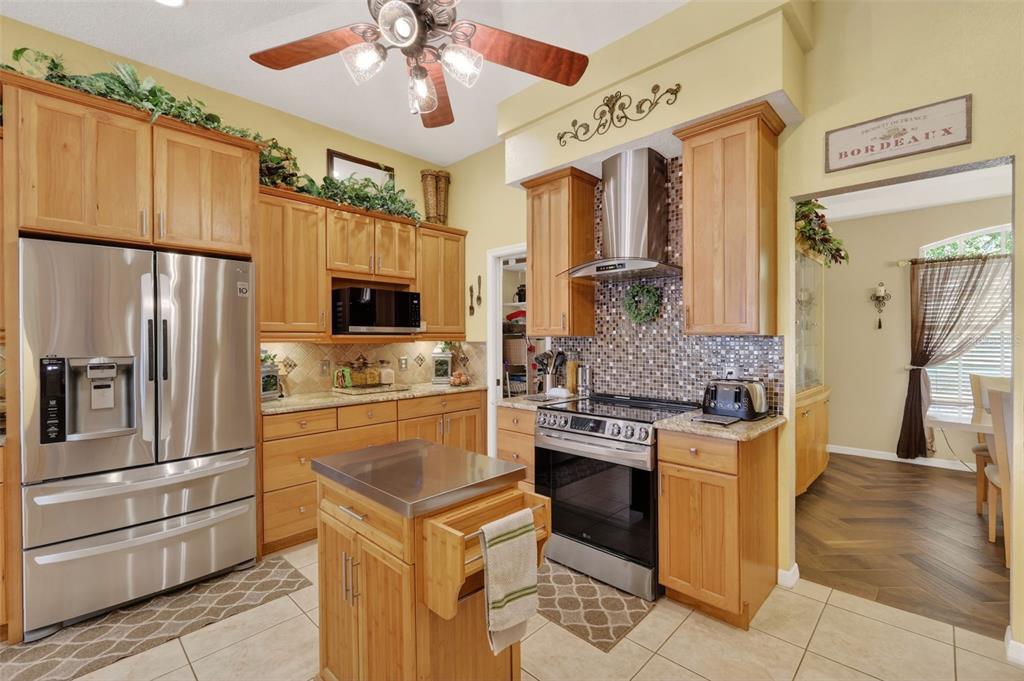 19703 Twin Ponds Road Umatilla, FL 32784 - Photo 21 of 62 a kitchen with stainless steel appliances granite countertop a refrigerator stove and sink