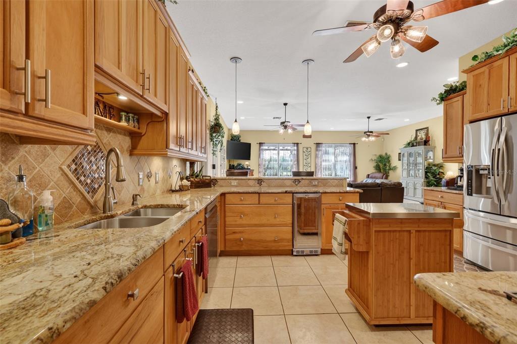 19703 Twin Ponds Road Umatilla, FL 32784 - Photo 22 of 62 a kitchen with stainless steel appliances granite countertop a sink a stove and a refrigerator
