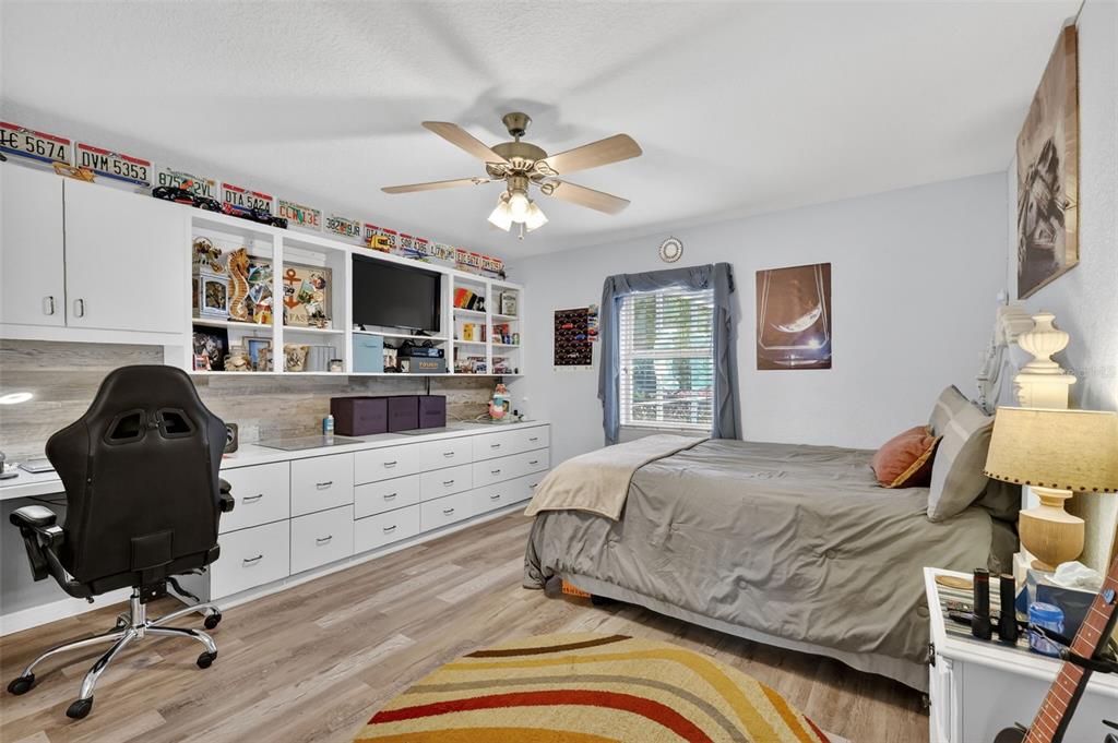 19703 Twin Ponds Road Umatilla, FL 32784 - Photo 26 of 62 a bedroom with a bed dresser and a flat screen tv