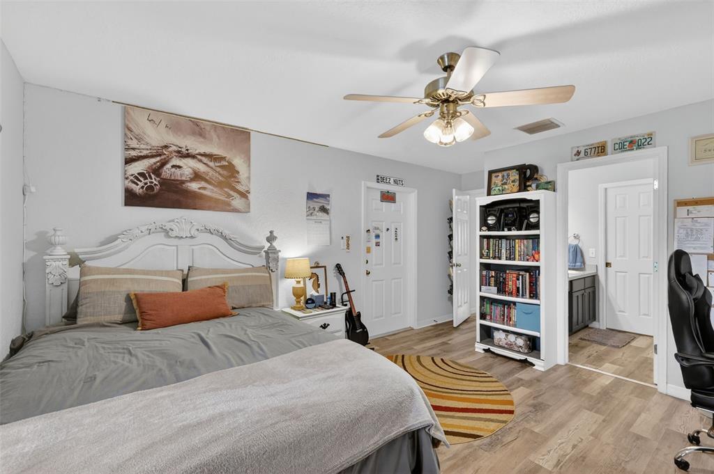 19703 Twin Ponds Road Umatilla, FL 32784 - Photo 27 of 62 a bedroom with a bed furniture and a chandelier