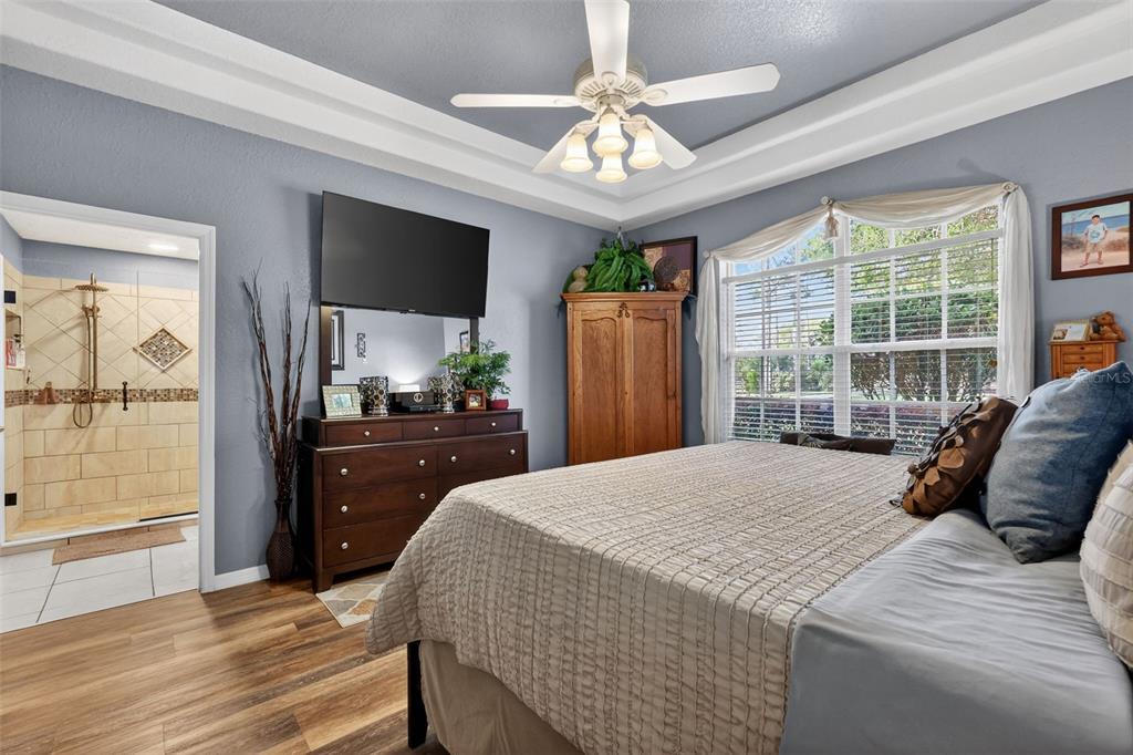 19703 Twin Ponds Road Umatilla, FL 32784 - Photo 32 of 62 a bedroom with a large bed and a large window