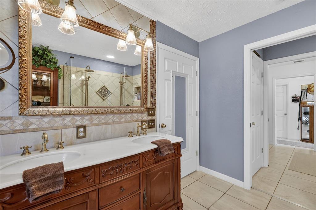 19703 Twin Ponds Road Umatilla, FL 32784 - Photo 35 of 62 a bathroom with a sink and a mirror