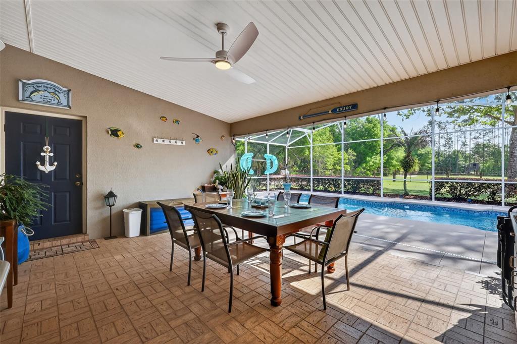 19703 Twin Ponds Road Umatilla, FL 32784 - Photo 37 of 62 a view of a patio with a table chairs and backyard