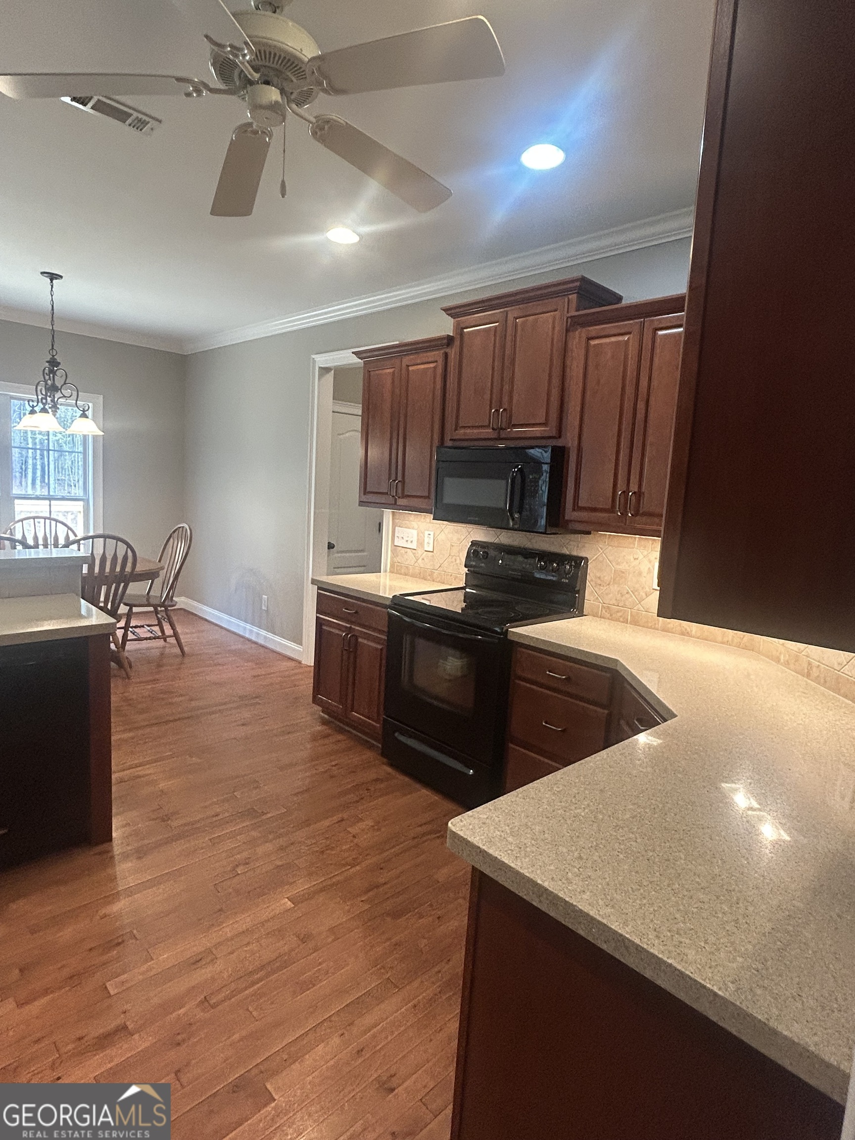 160 Walnut Ridge Way Covington, GA 30014 - Photo 19 of 36 a kitchen with granite countertop a stove a sink and a refrigerator