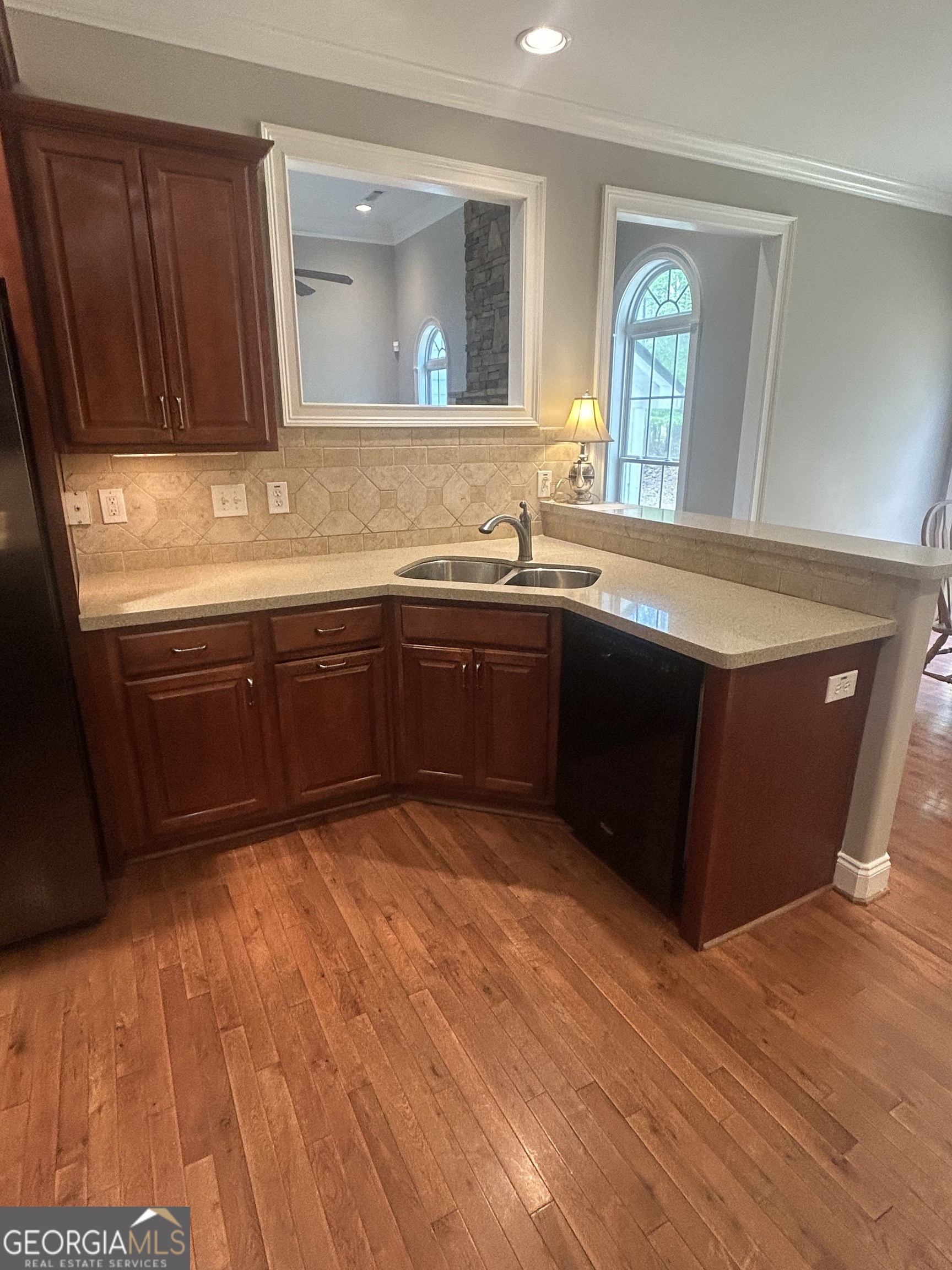 160 Walnut Ridge Way Covington, GA 30014 - Photo 21 of 36 a kitchen with stainless steel appliances granite countertop a sink and cabinets with wooden floor