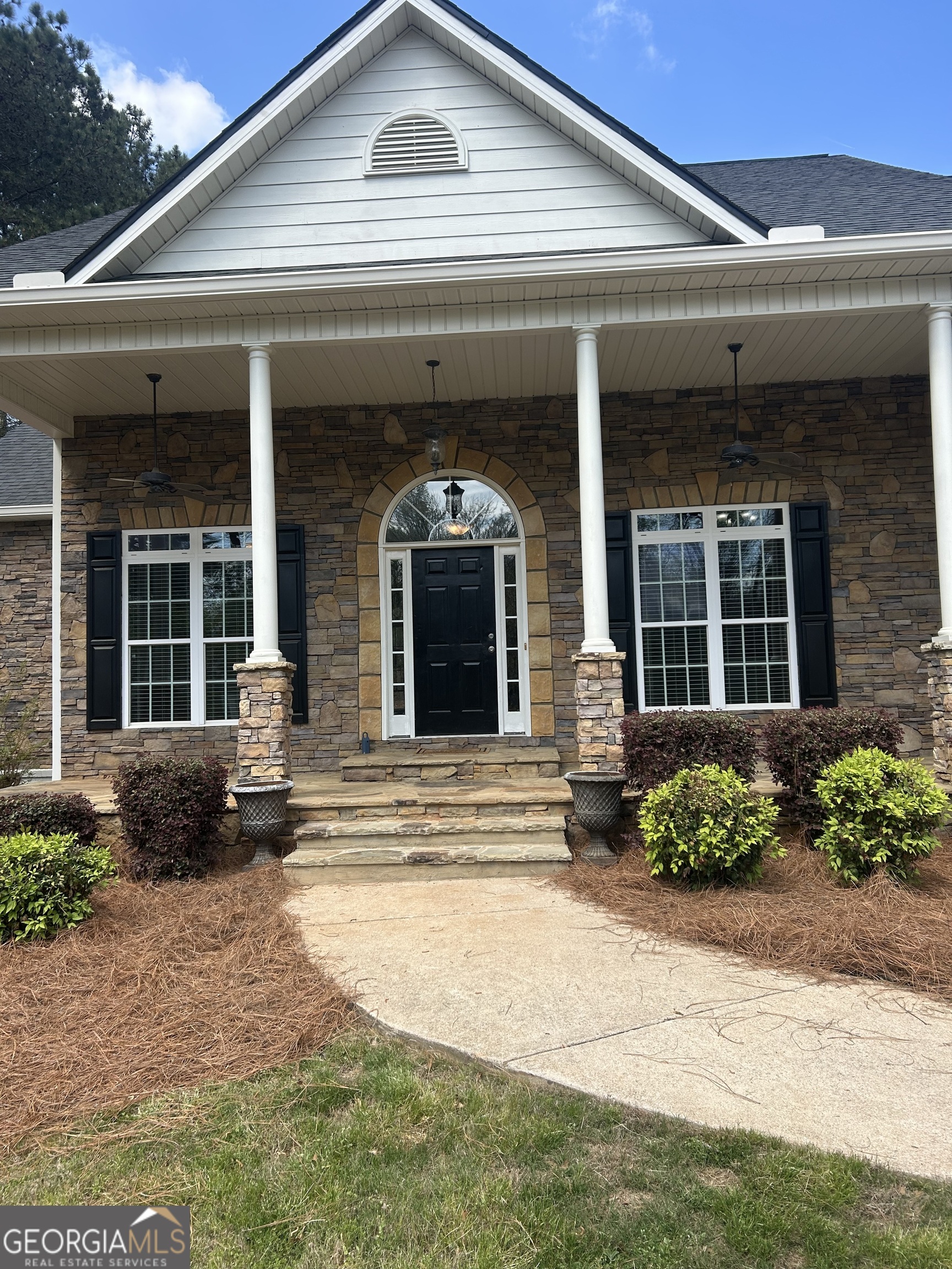 160 Walnut Ridge Way Covington, GA 30014 - Photo 3 of 36 a front view of a brick house with potted plants