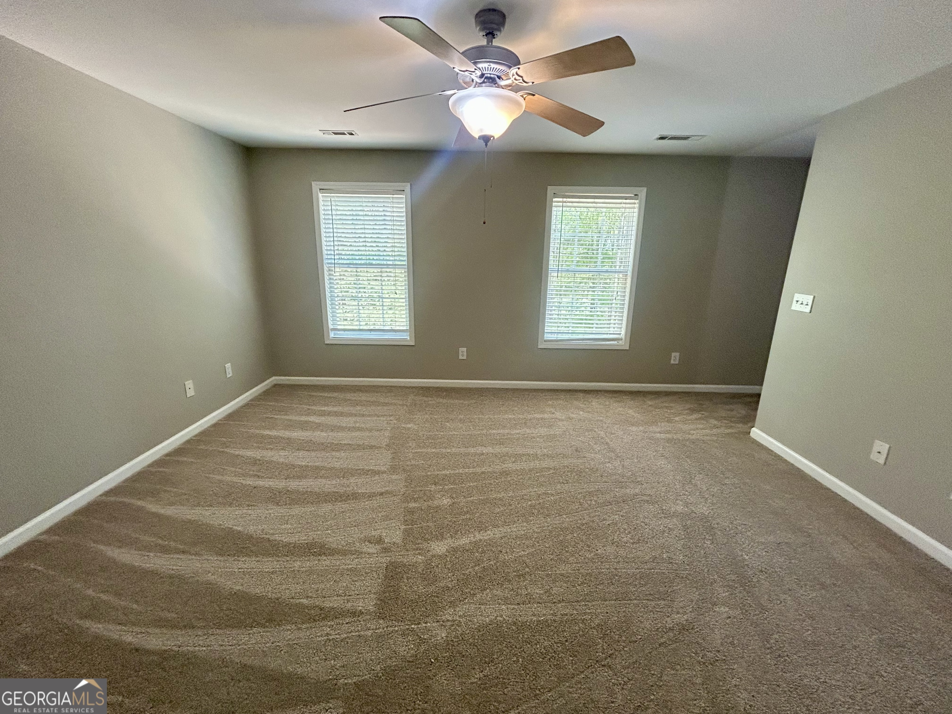 160 Walnut Ridge Way Covington, GA 30014 - Photo 33 of 36 a view of an empty room with window and chandelier fan