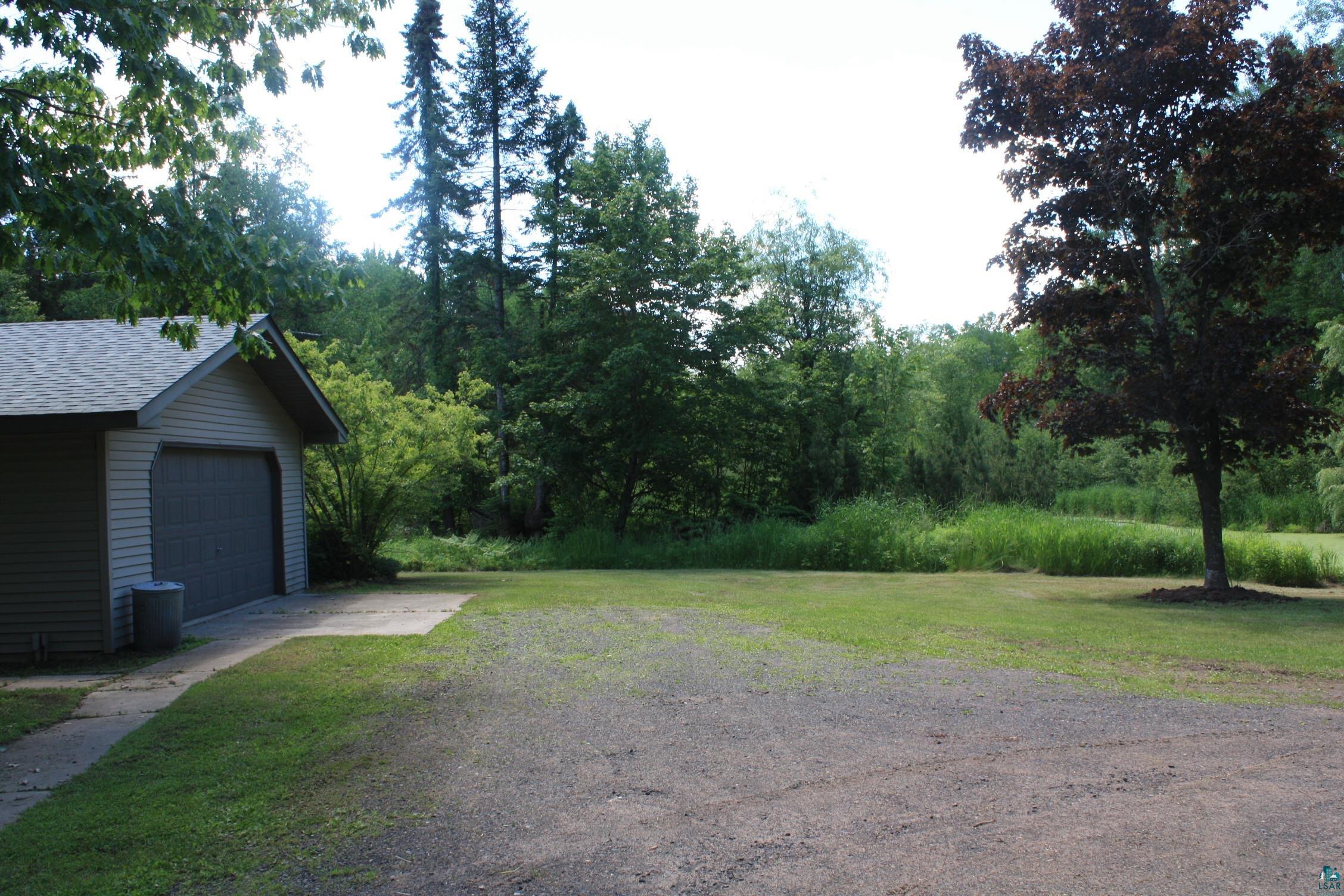 6718 East County Rd B South Range, WI 54874 - Photo 7 of 50 View of yard with a garage and an outdoor structure