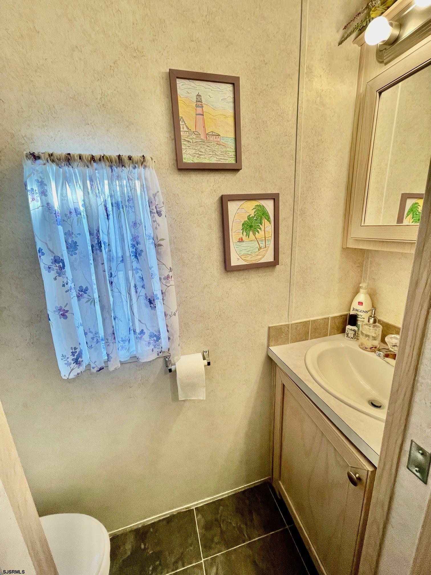 4100 Rte 9 South, Unit 19 Rio Grande, NJ 08242 - Photo 15 of 23 a bathroom with a sink and a mirror