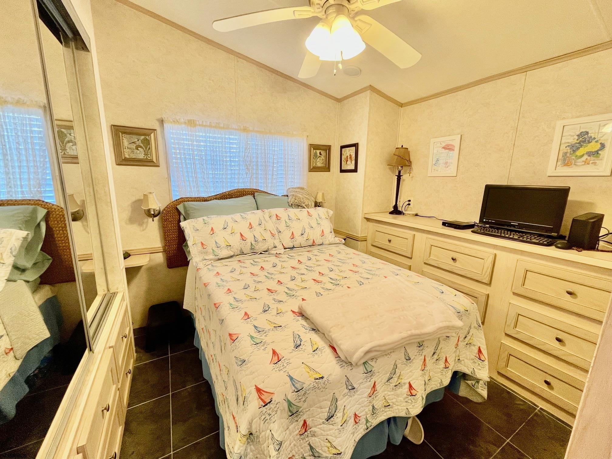 4100 Rte 9 South, Unit 19 Rio Grande, NJ 08242 - Photo 10 of 23 a bedroom with a bed and a chandelier