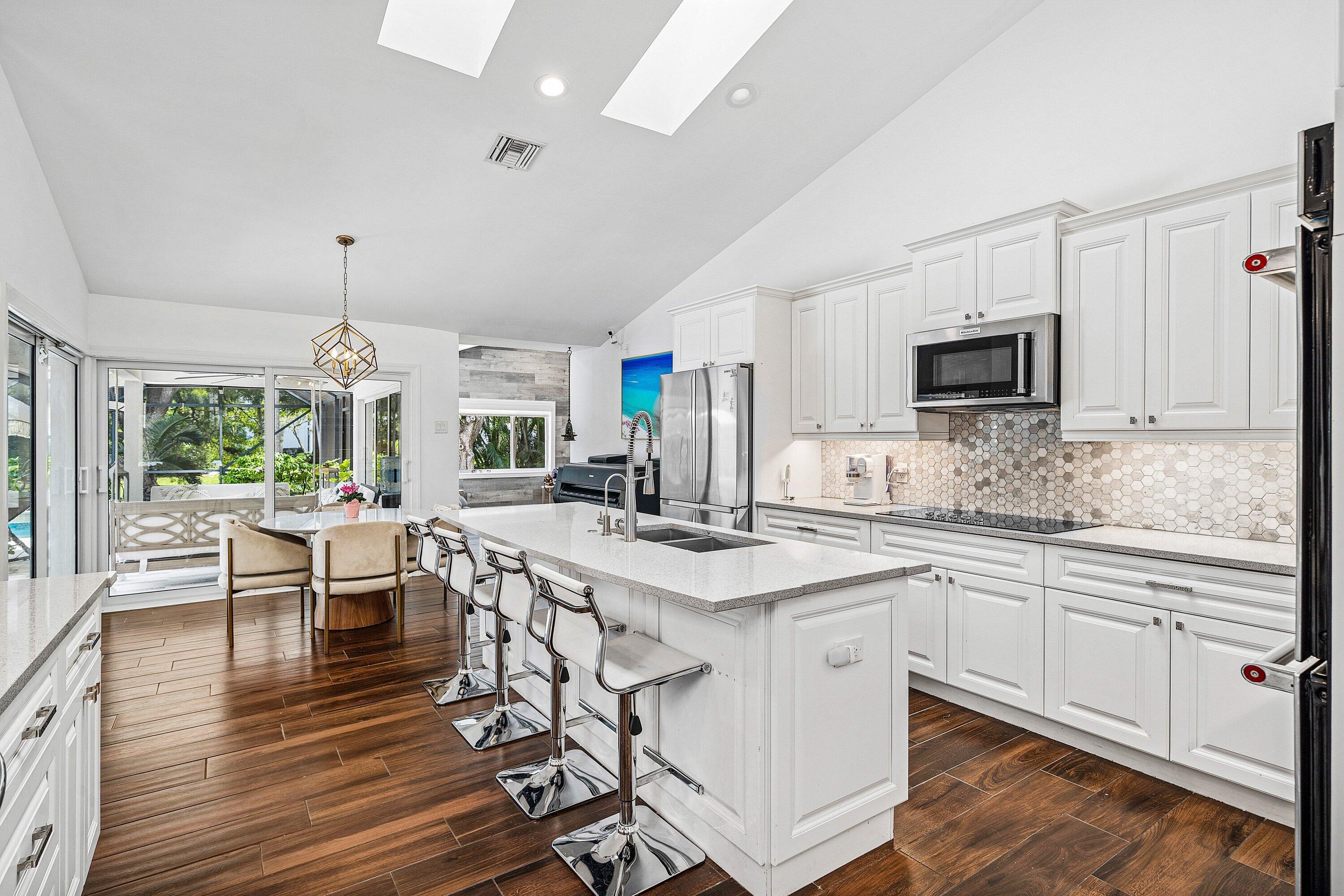 3030 Canterbury Drive Boca Raton, FL 33434 - Photo 15 of 45 a kitchen with stainless steel appliances granite countertop a stove and cabinets a sink with wooden floor