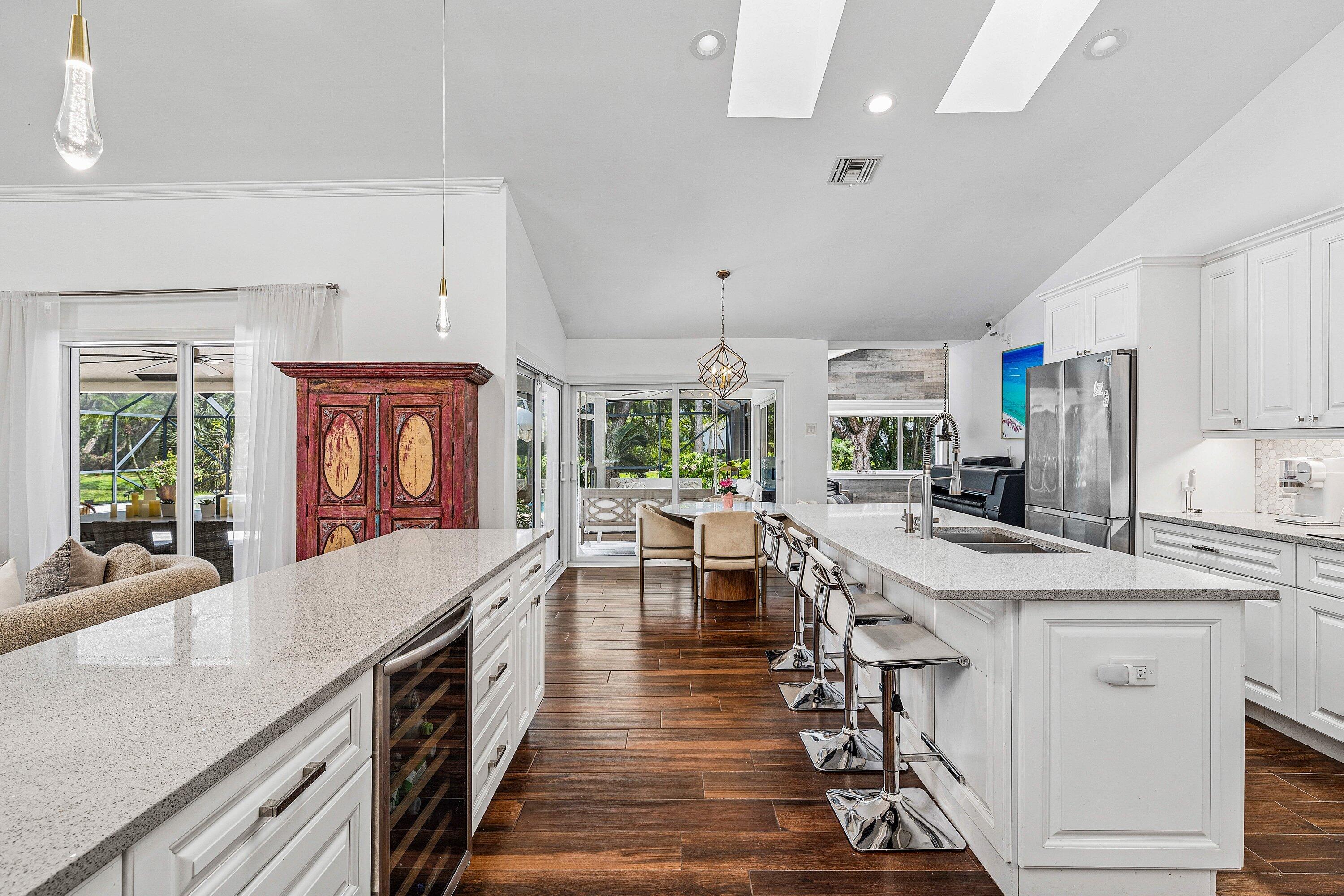3030 Canterbury Drive Boca Raton, FL 33434 - Photo 16 of 45 a large kitchen with stainless steel appliances lots of counter space and a table in it