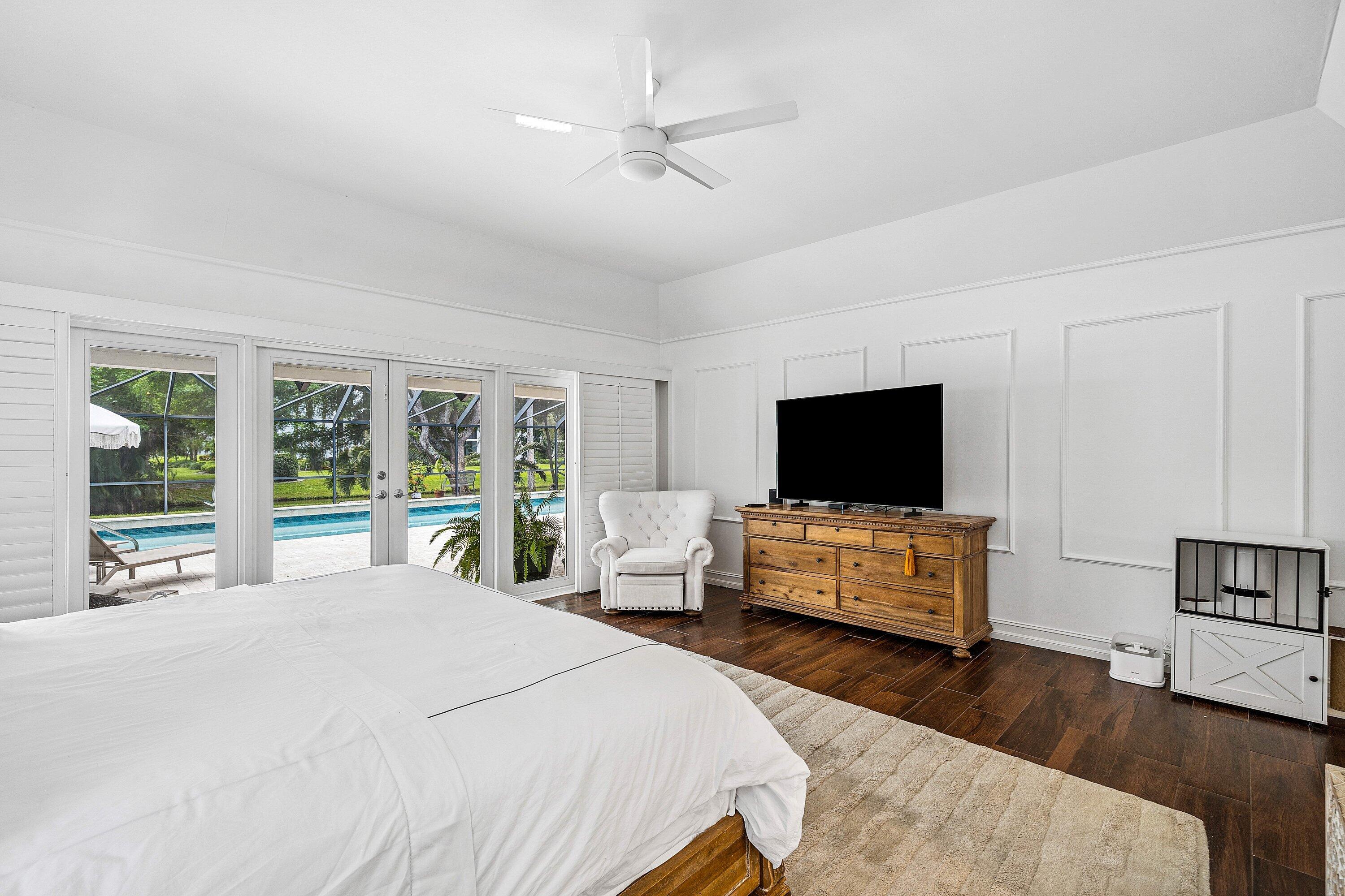 3030 Canterbury Drive Boca Raton, FL 33434 - Photo 21 of 45 a bedroom with a bed and a flat screen tv