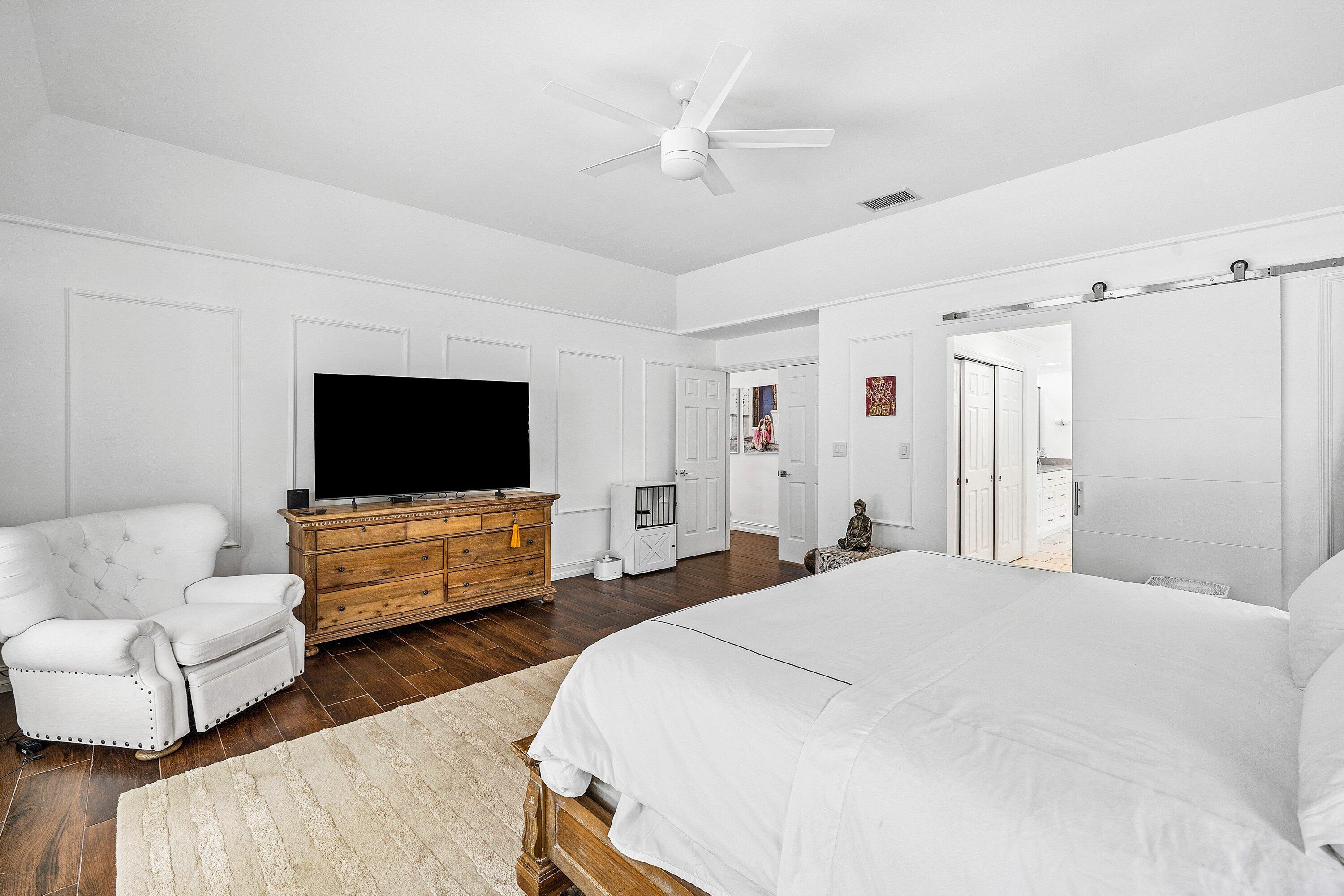 3030 Canterbury Drive Boca Raton, FL 33434 - Photo 22 of 45 a bedroom with furniture and a flat screen tv