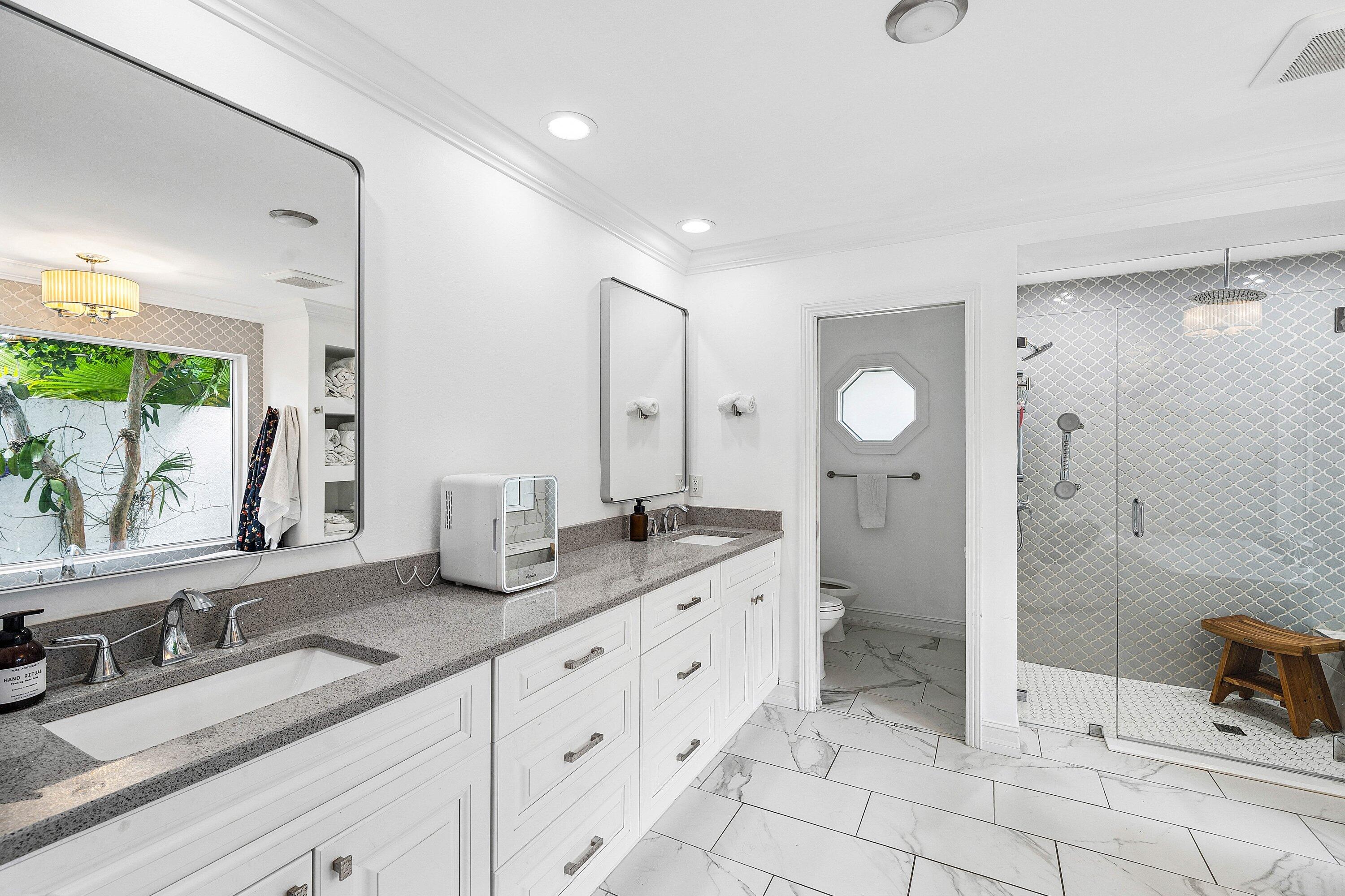 3030 Canterbury Drive Boca Raton, FL 33434 - Photo 23 of 45 a spacious bathroom with double sink and a mirror