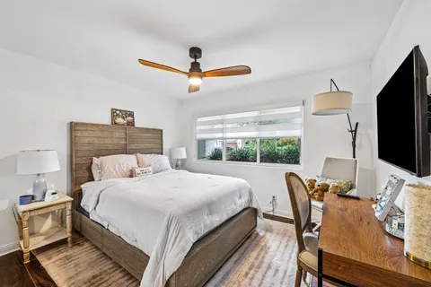 a bedroom with a bed and a flat screen tv