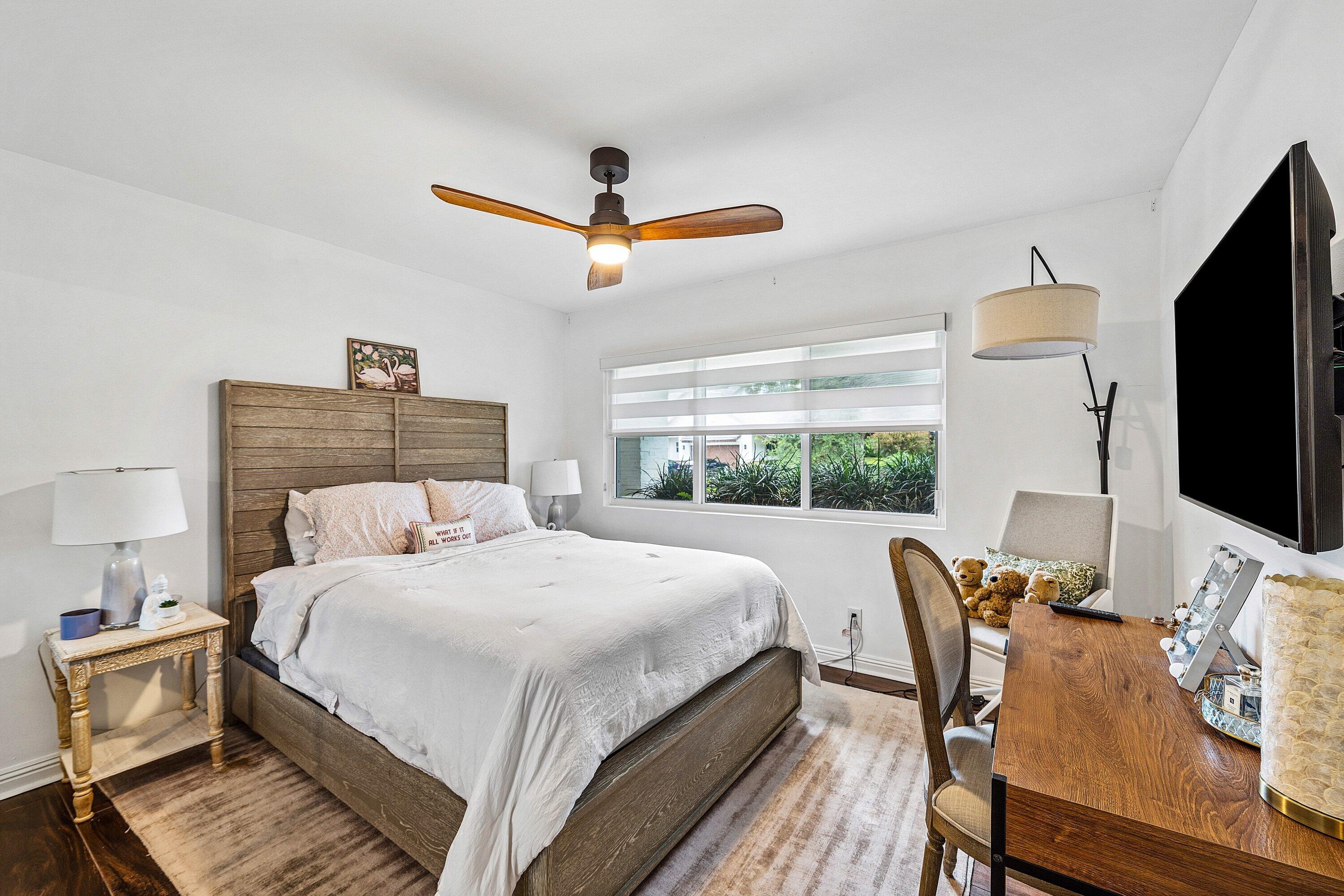 3030 Canterbury Drive Boca Raton, FL 33434 - Photo 25 of 45 a bedroom with a bed and a flat screen tv