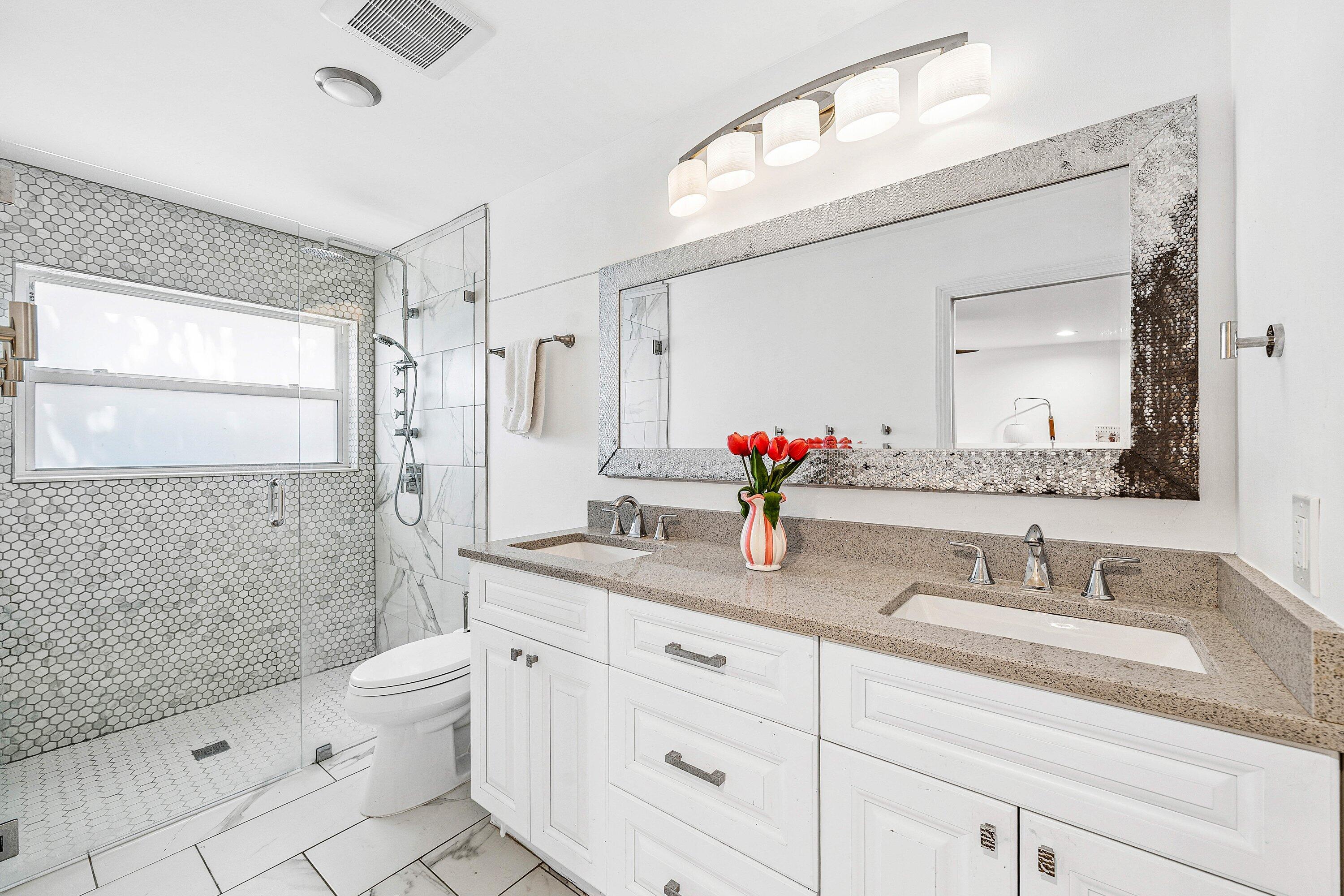 3030 Canterbury Drive Boca Raton, FL 33434 - Photo 28 of 45 a bathroom with a granite countertop sink mirror vanity and toilet
