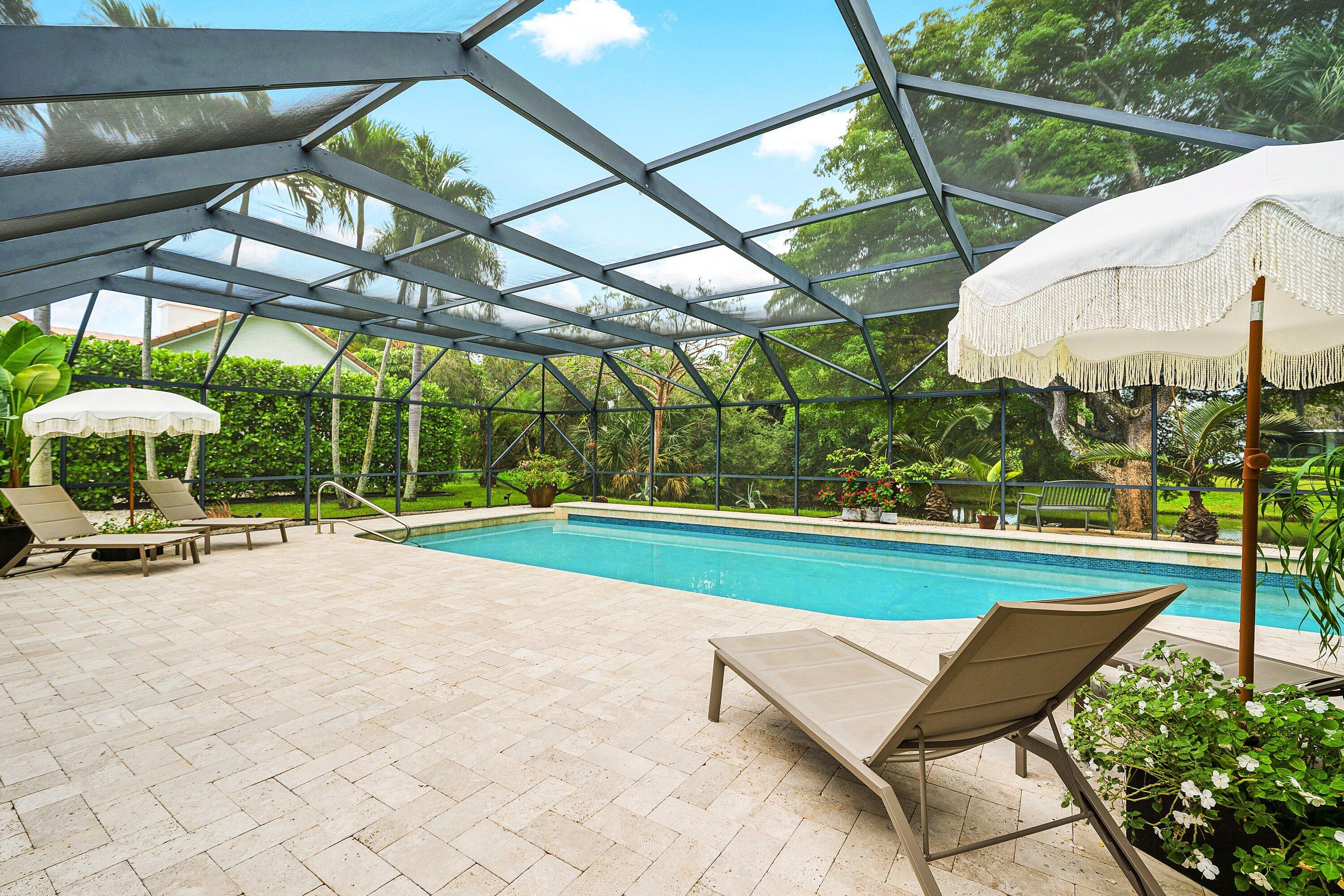 3030 Canterbury Drive Boca Raton, FL 33434 - Photo 33 of 45 a view of a backyard with table and chairs under an umbrella