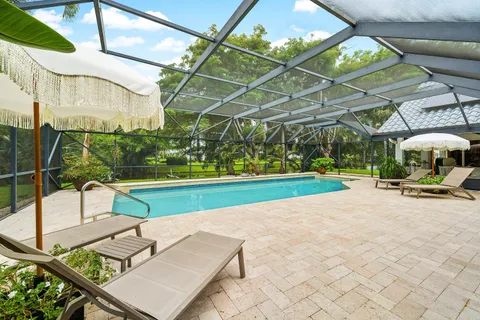 a view of yard with swimming pool and sitting area