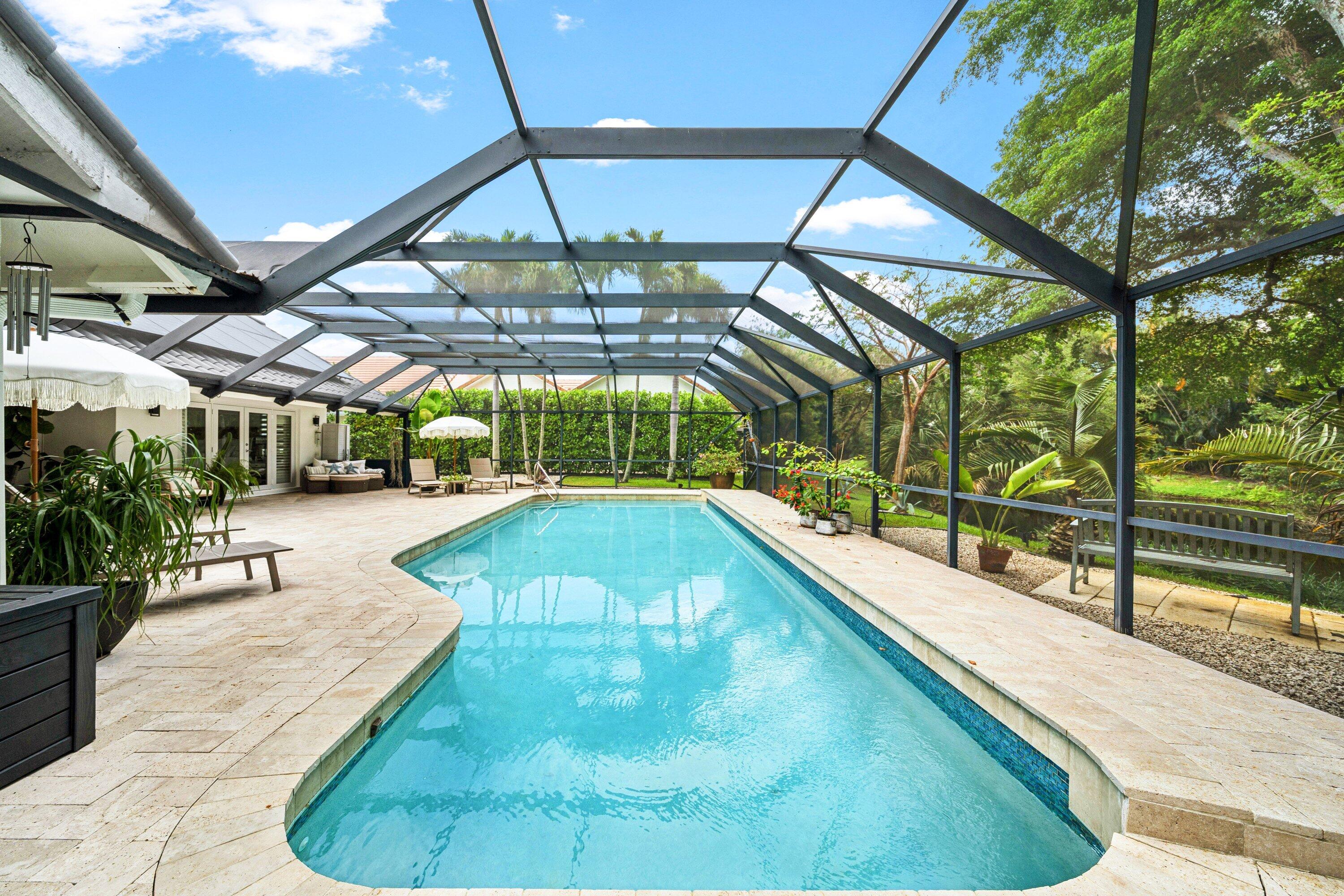 3030 Canterbury Drive Boca Raton, FL 33434 - Photo 36 of 45 a view of a swimming pool with a patio and plants