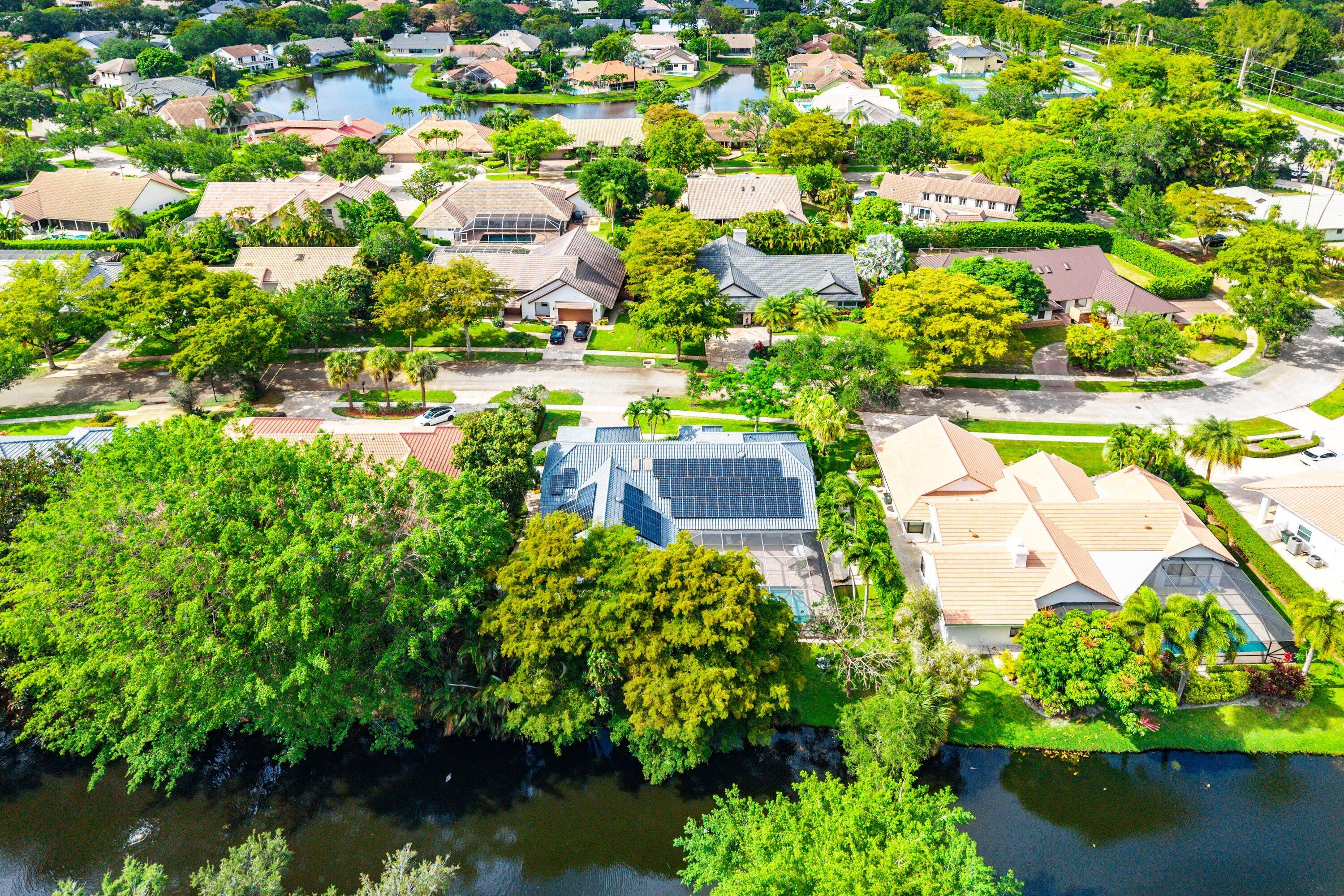 3030 Canterbury Drive Boca Raton, FL 33434 - Photo 43 of 45 an aerial view of a house with a garden and lake view