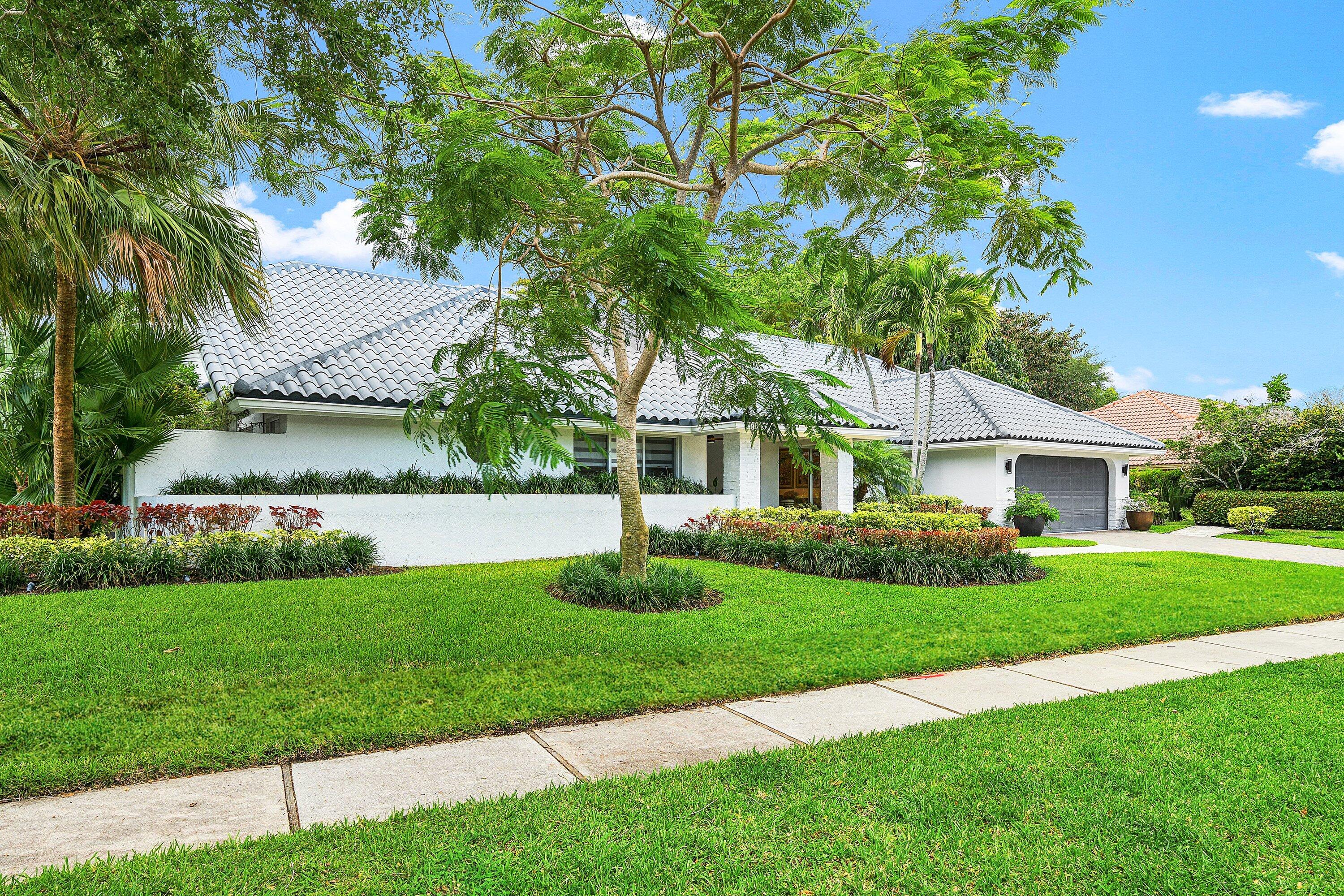 3030 Canterbury Drive Boca Raton, FL 33434 - Photo 44 of 45 a front view of a house with a yard