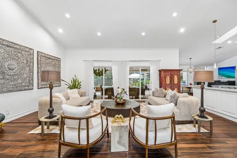 a living room with fireplace furniture and a wooden floor