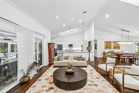 a living room with furniture and a dining table