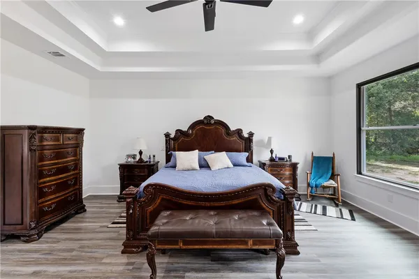 a bedroom with a bed a table and chair