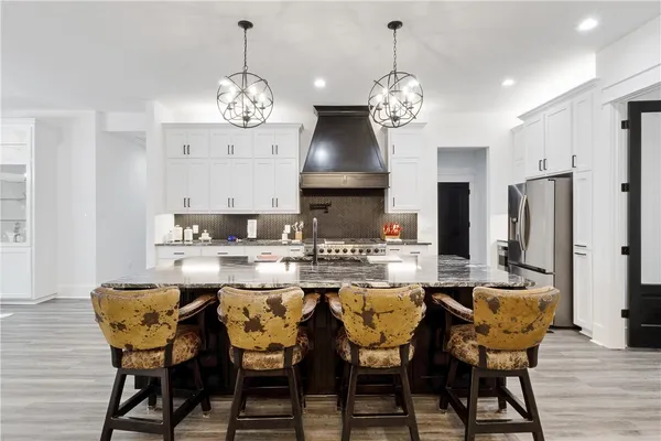 a view of a dining room with furniture wooden floor and chandelier