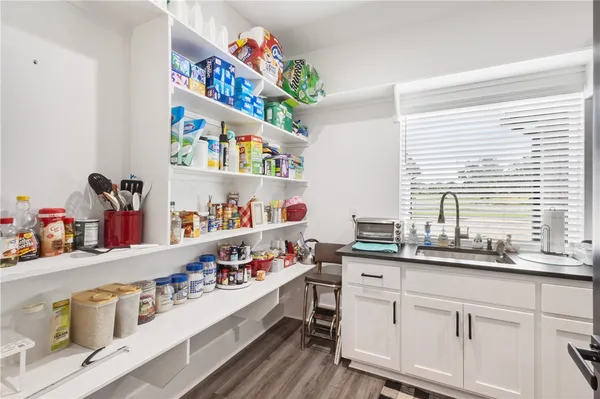 a kitchen with stainless steel appliances a sink a stove and a window