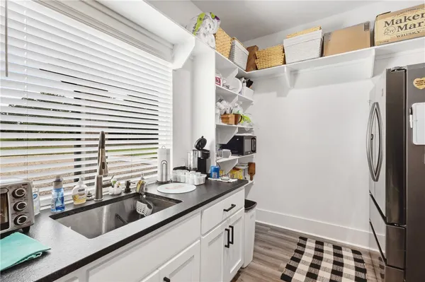 a kitchen with a sink and a refrigerator