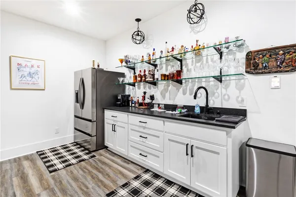 a kitchen with refrigerator and cabinets
