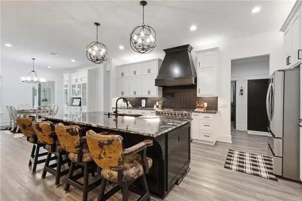 a large kitchen with a table and chairs
