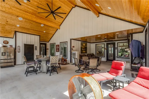 a view of a big room with swimming pool and outdoor seating