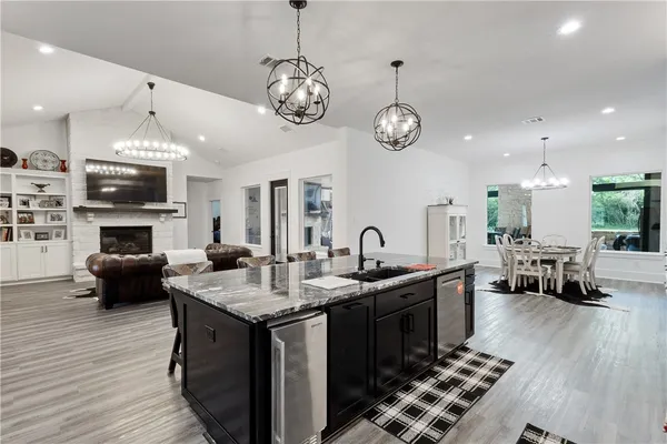 a kitchen with sink stove and cabinets