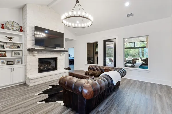 a living room with furniture fireplace and flat screen tv