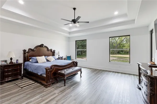 a spacious bedroom with a bed and window