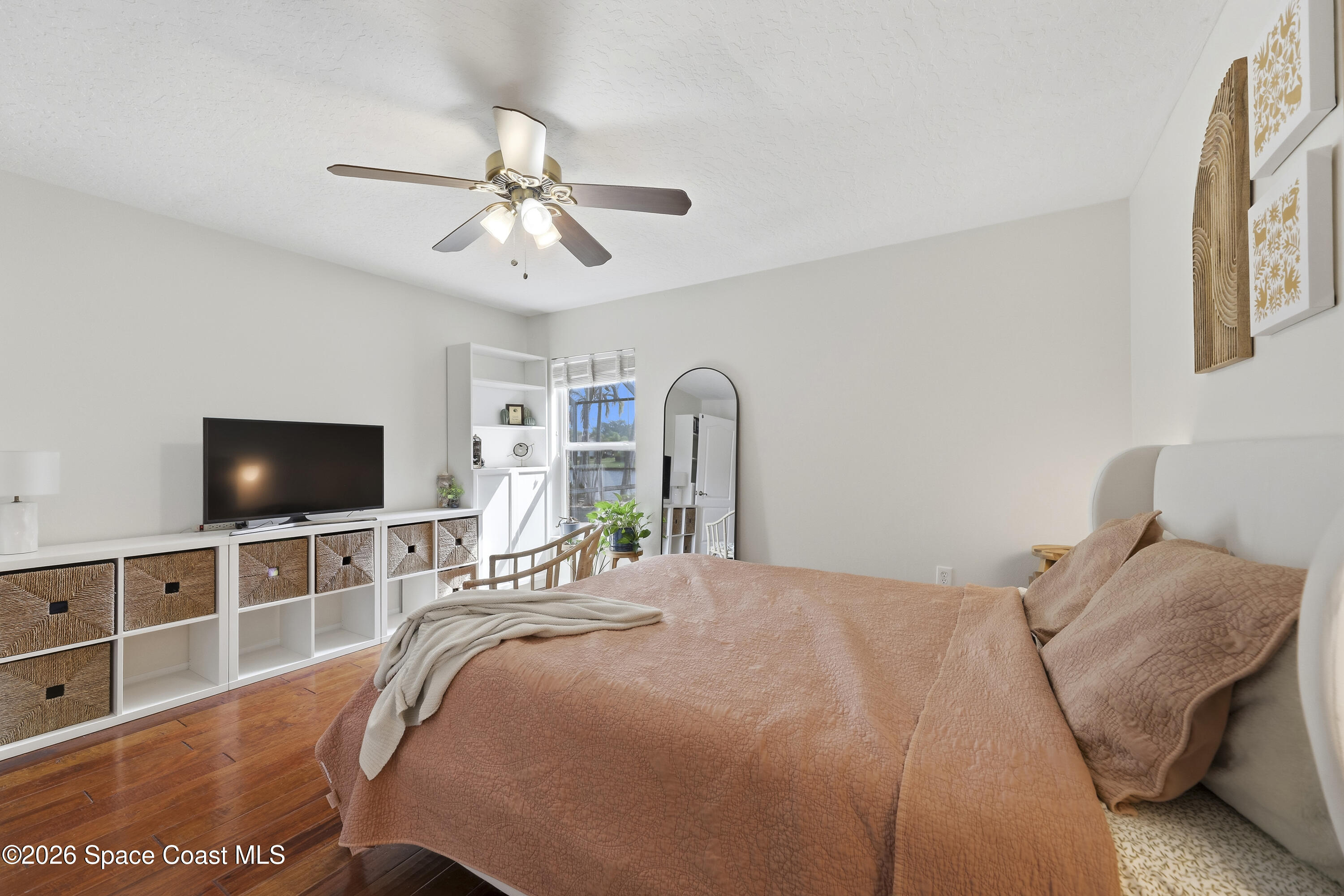 1643 Long Pine Road Melbourne, FL 32940 - Photo 35 of 63 a bedroom with a bed and a flat screen tv
