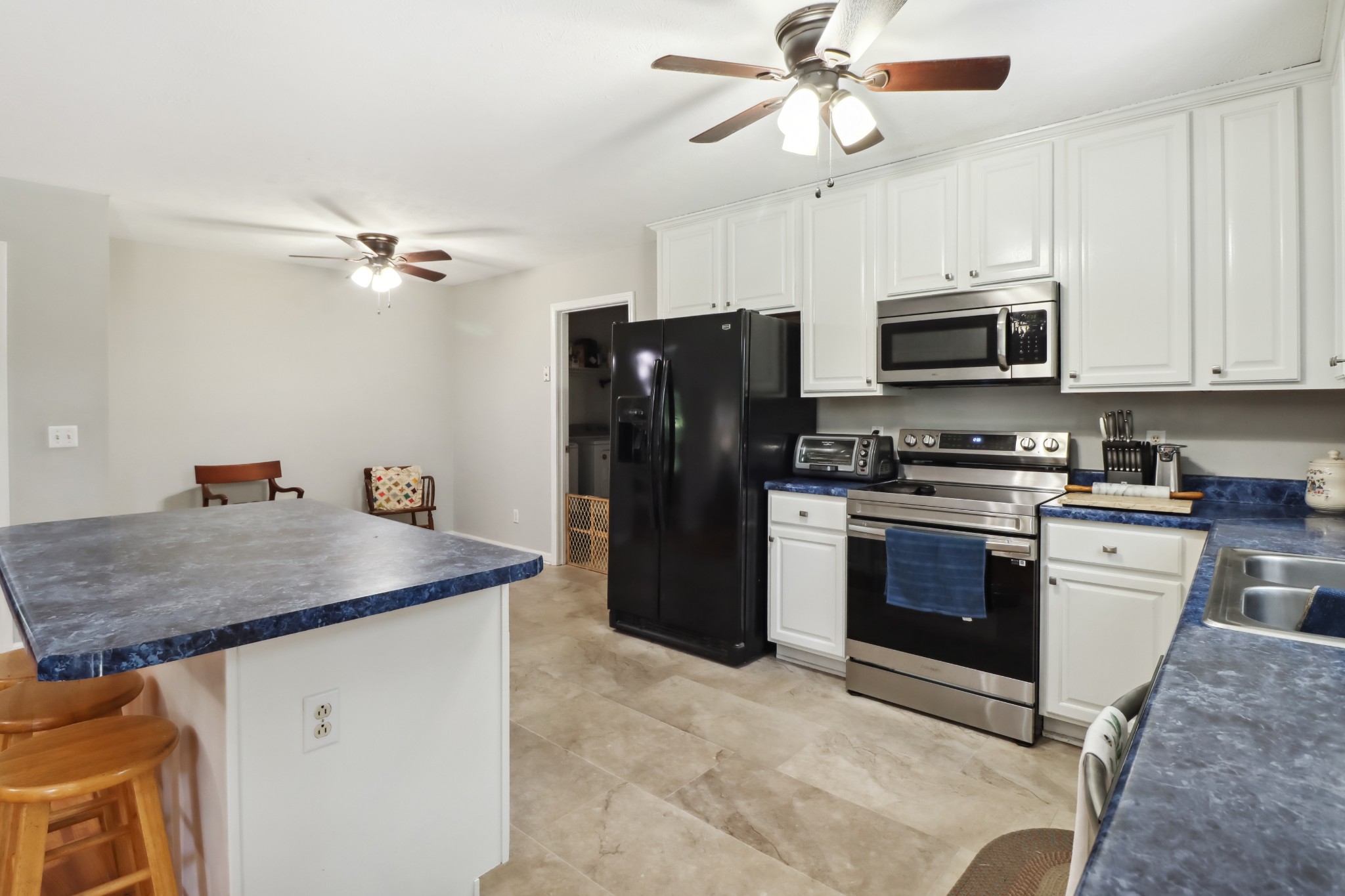 4956 Minnis Road Springfield, TN 37172 - Photo 23 of 32 a kitchen with stainless steel appliances granite countertop a refrigerator a stove a sink and a sink