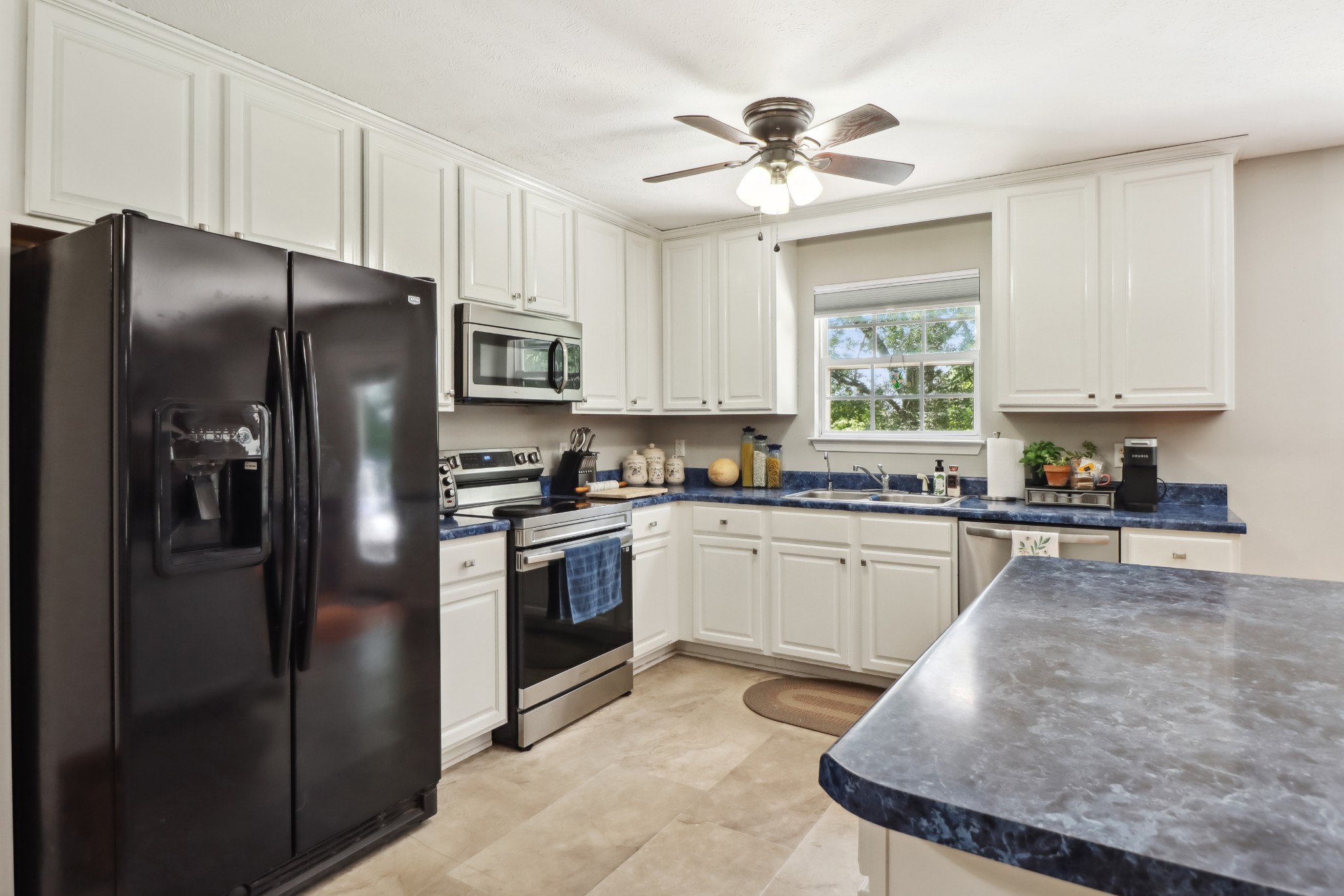 4956 Minnis Road Springfield, TN 37172 - Photo 24 of 32 a kitchen with stainless steel appliances granite countertop a refrigerator a stove a sink and a microwave